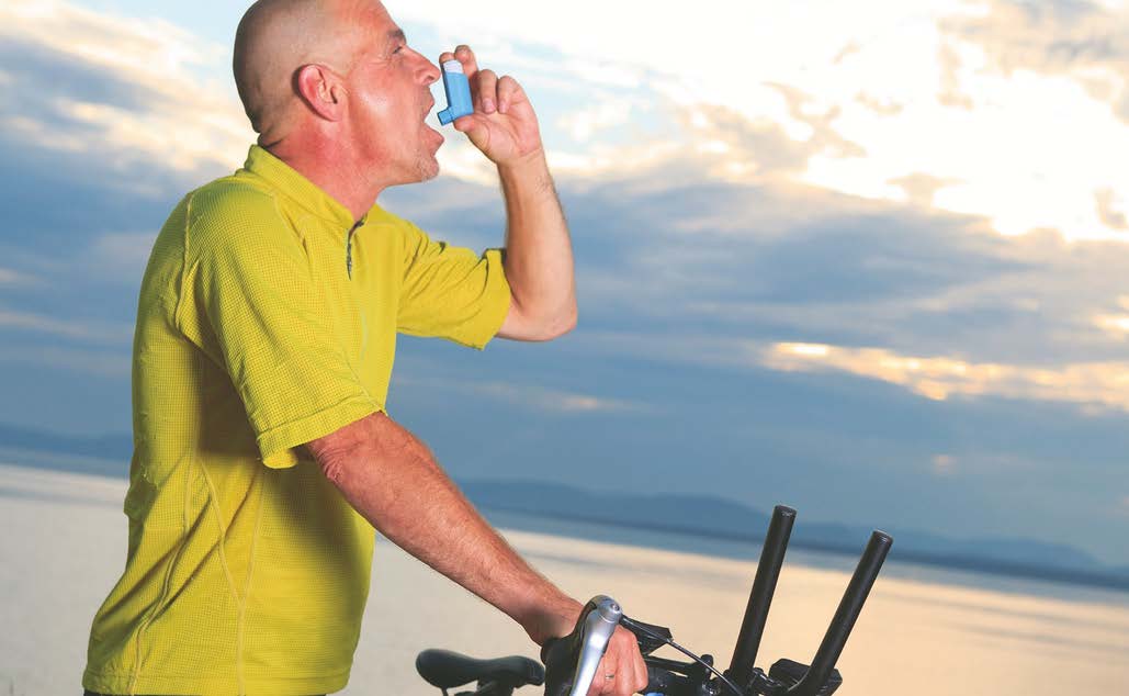 man on bicycle with inhaler